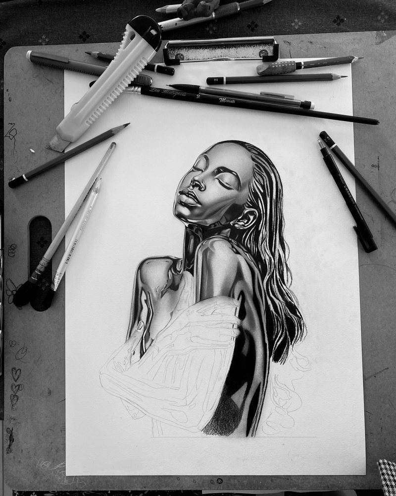 Sade As A Trophy in progress: the chrome face and shoulders are finished, the arms still sketched, with pencils and a cutter around the sheet.